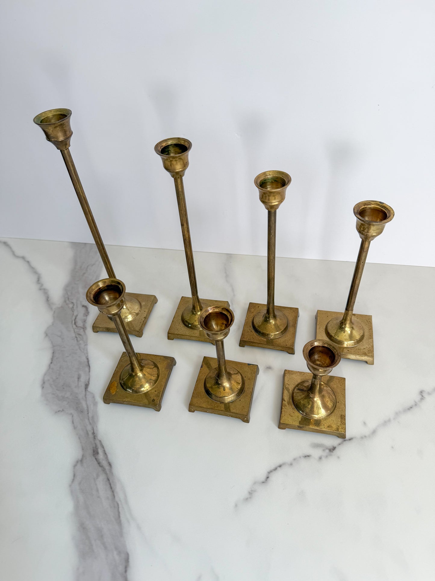 Set of Seven Brass Taper Candle Holders with Square Bases